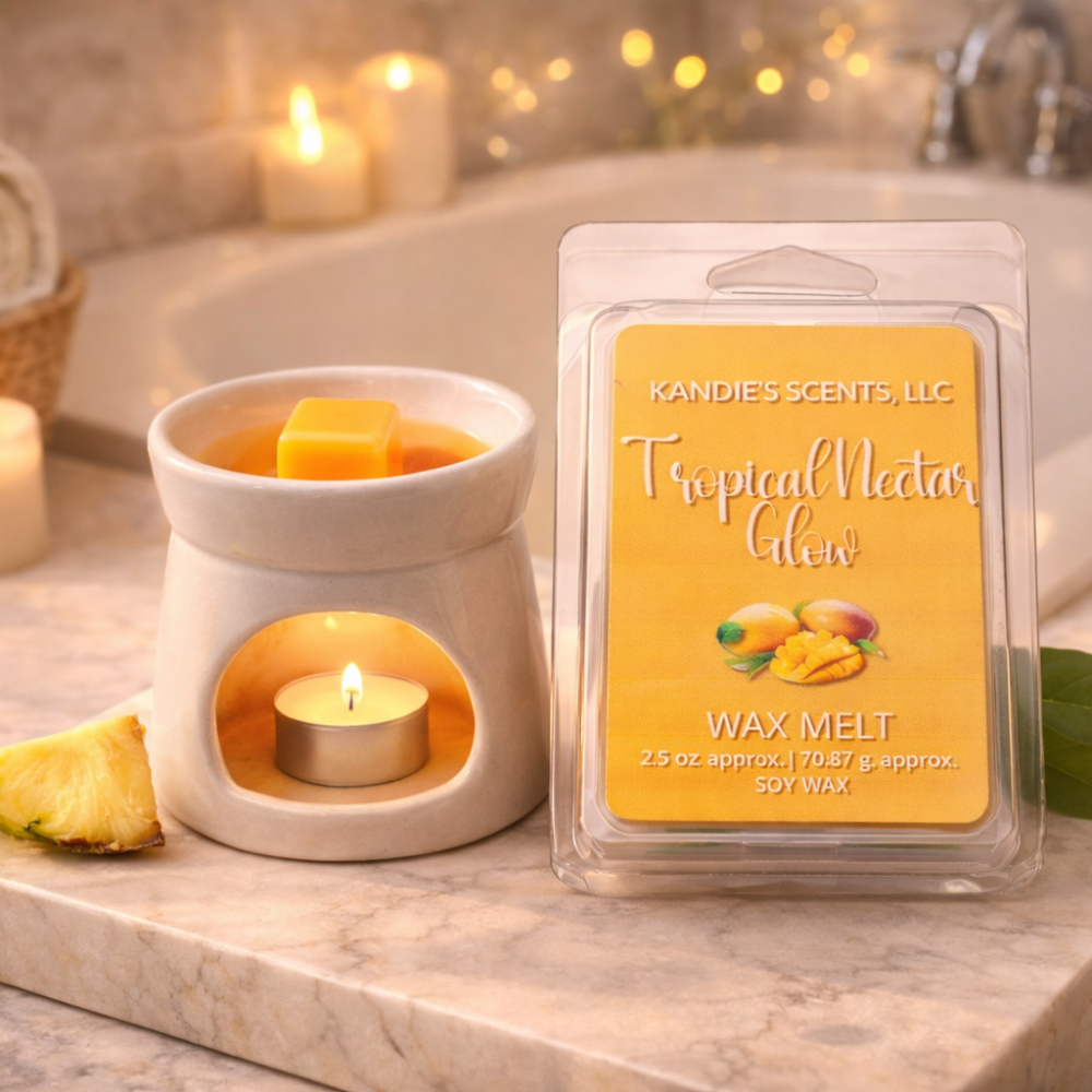 Kandie's Scents wax melt packaging with a lit wax melt in an warmer on a marble surface.