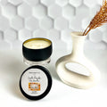 Matte black tin candle with creamy fall fragrance