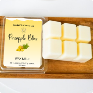 A package of Pineapple Bliss wax melts by Kandie's Scents displayed on a wooden surface, with the product name and a small image of a pineapple on the packaging.