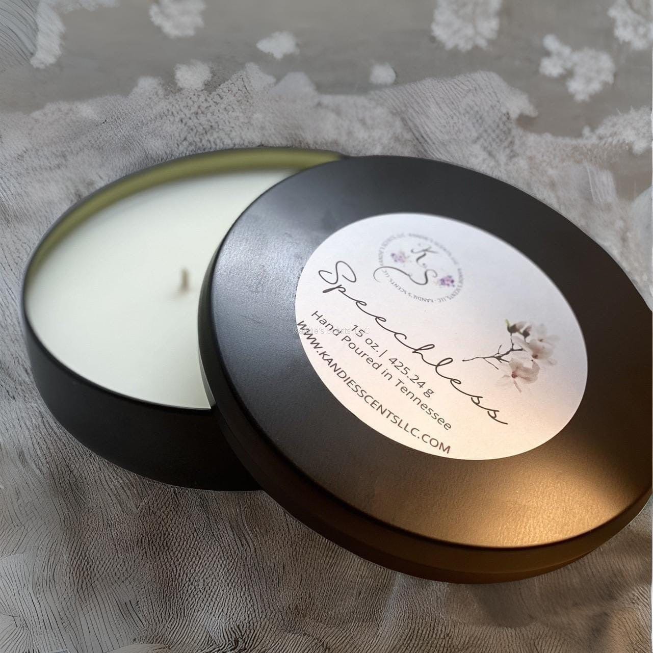 Matte black soy blend candle tin with cozy warm fragrance
