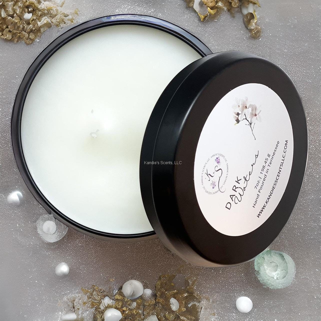 Matte black travel tin candle with ocean-inspired musk scent