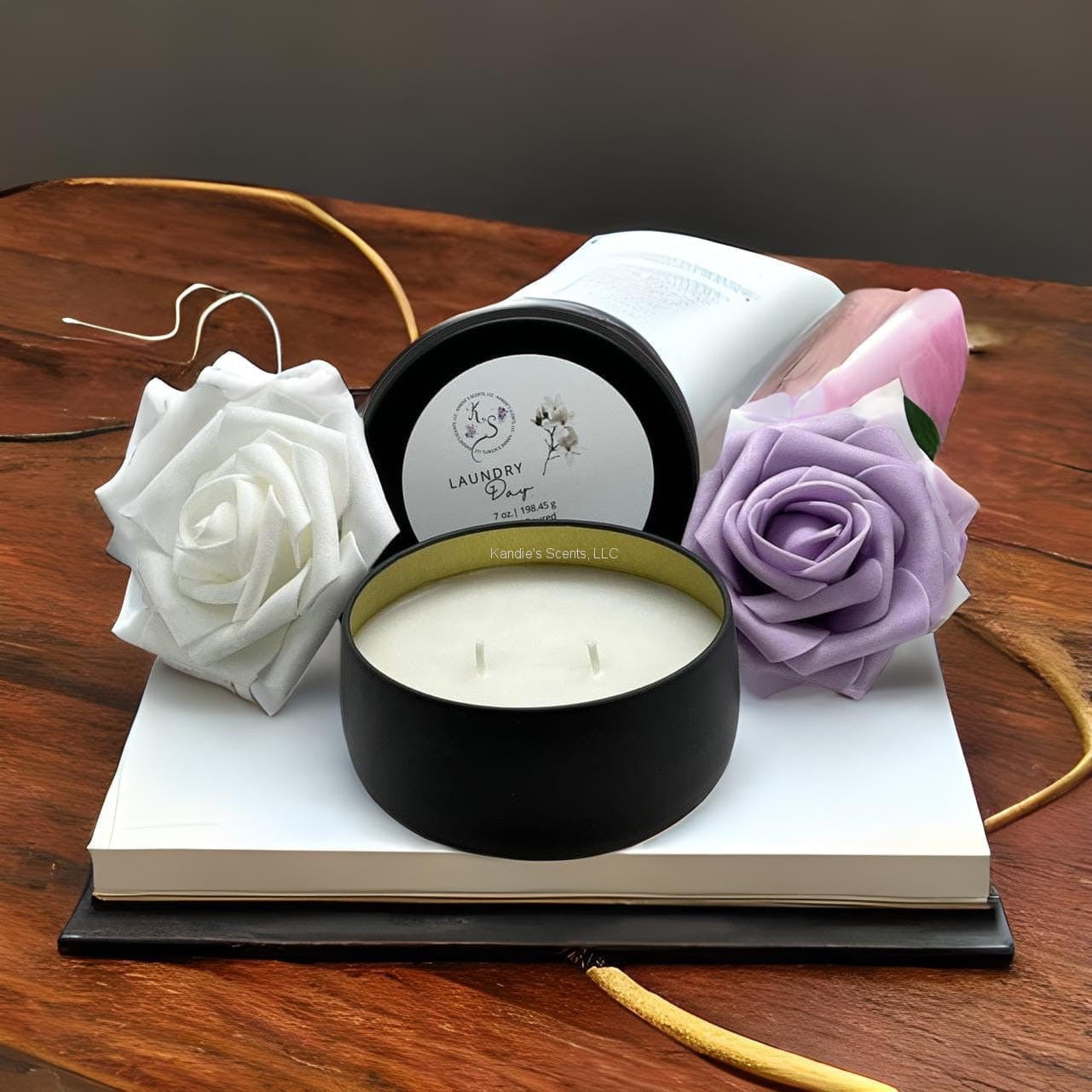 Matte black soy candle tin with clean laundry fragrance