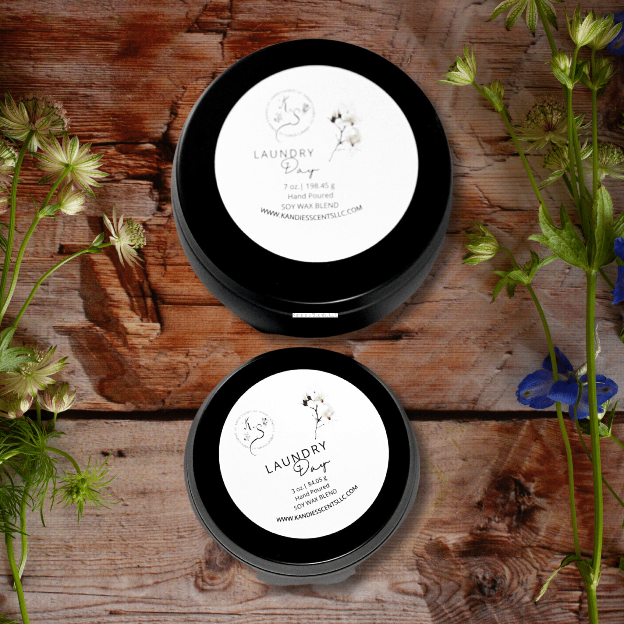 Matte black soy candle tins with clean laundry fragrance